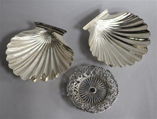 A pair of white metal butter shells and a late Victorian pierced silver nut dish.